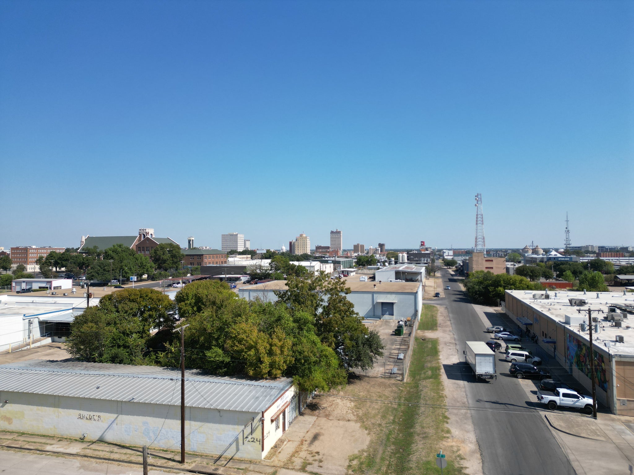 Drone photo of Economy Supply in Waco Texas with Downtown Waco in the background